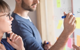 Sample of workflow strategy written over a wall